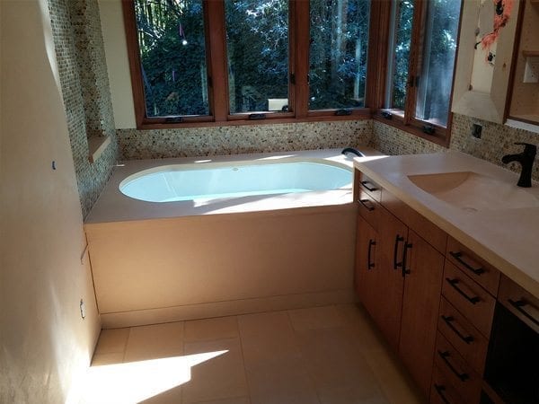 Tan Concrete Bath Tub Surround With Vanity Top